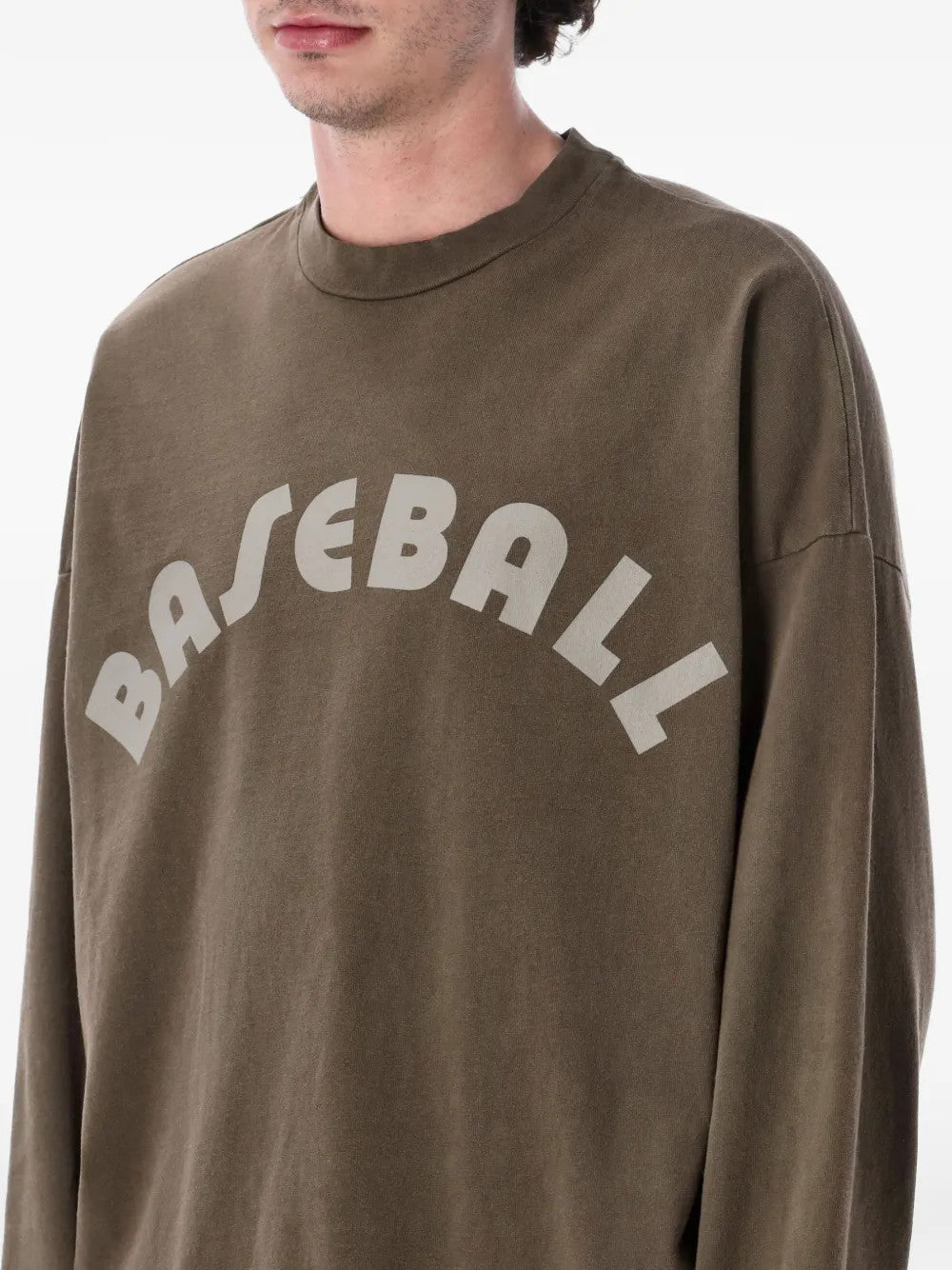 Brown t-shirt worn by a person, showing the t-shirt fit