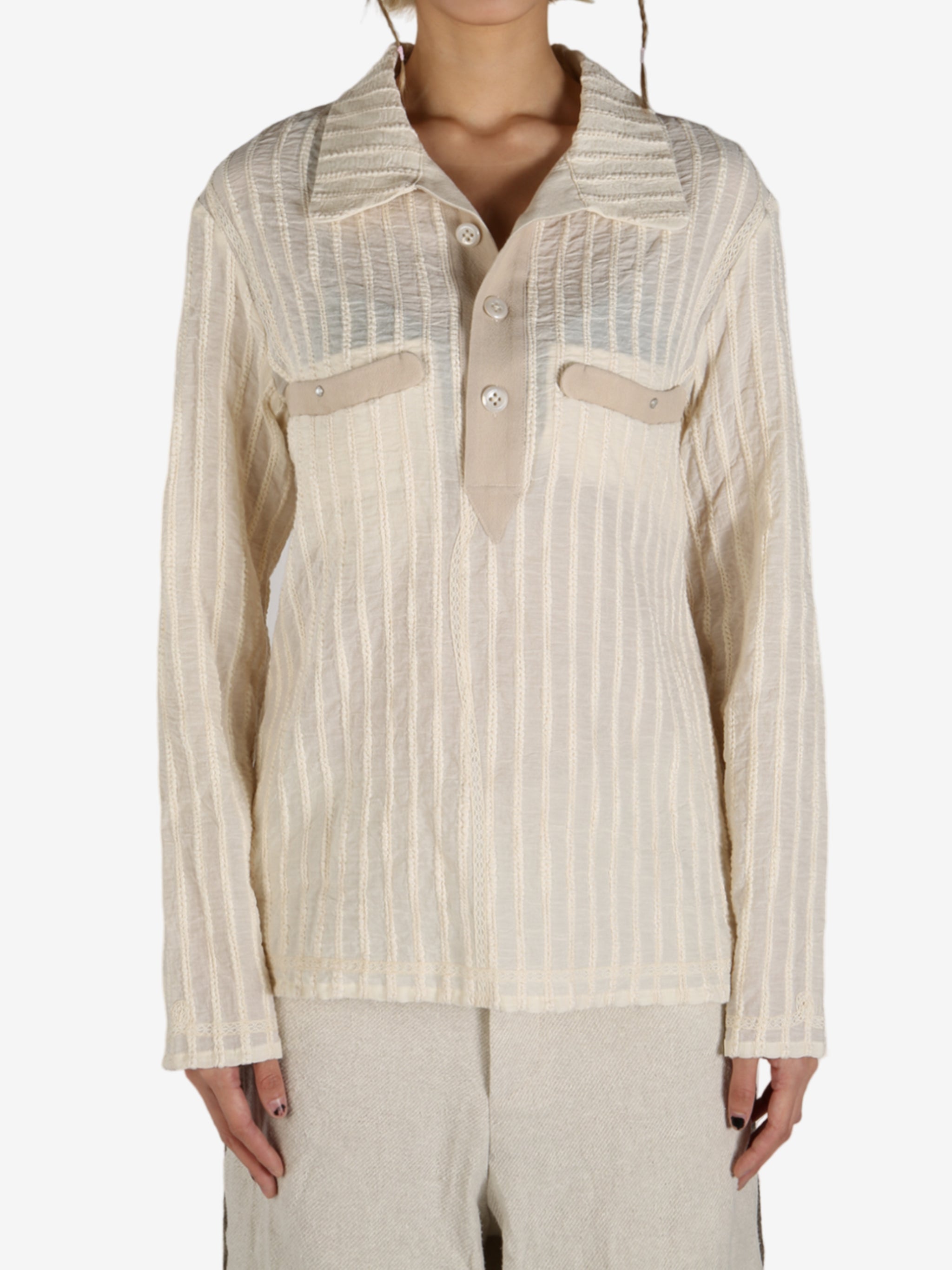 Tan shirt worn by a person, showing the shirt’s fit