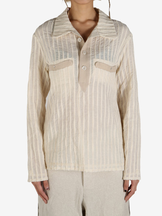 Tan shirt worn by a person, showing the shirt’s fit