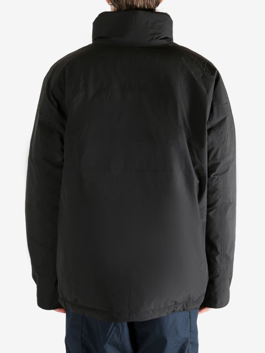 Black jacket worn by a person, showing the jacket's fit