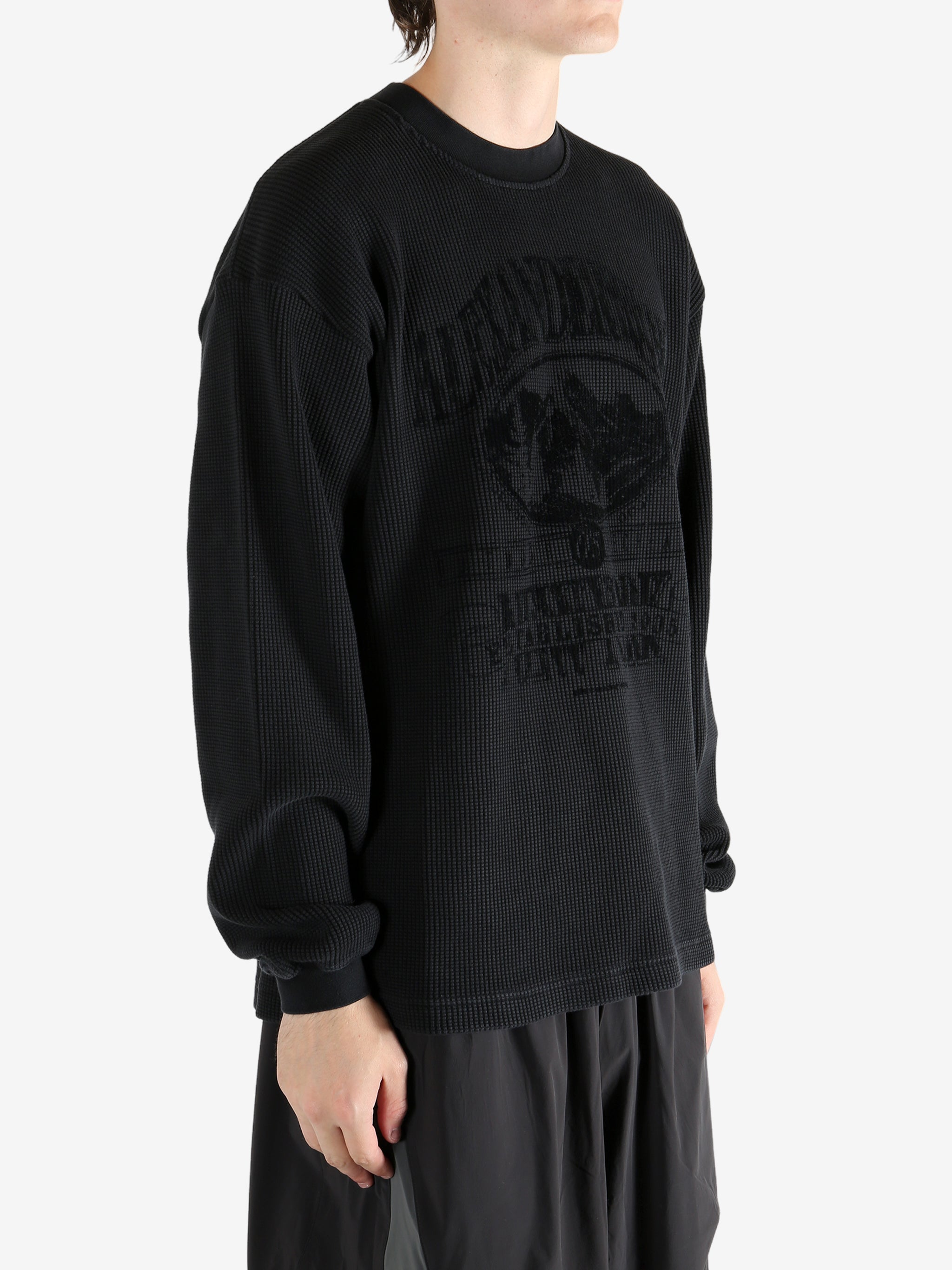 Black t-shirt worn by a person, showing the t-shirt's fit