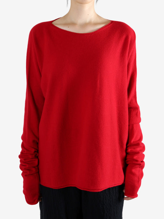 Red knitwear worn by a person, showing the knitwear's fit
