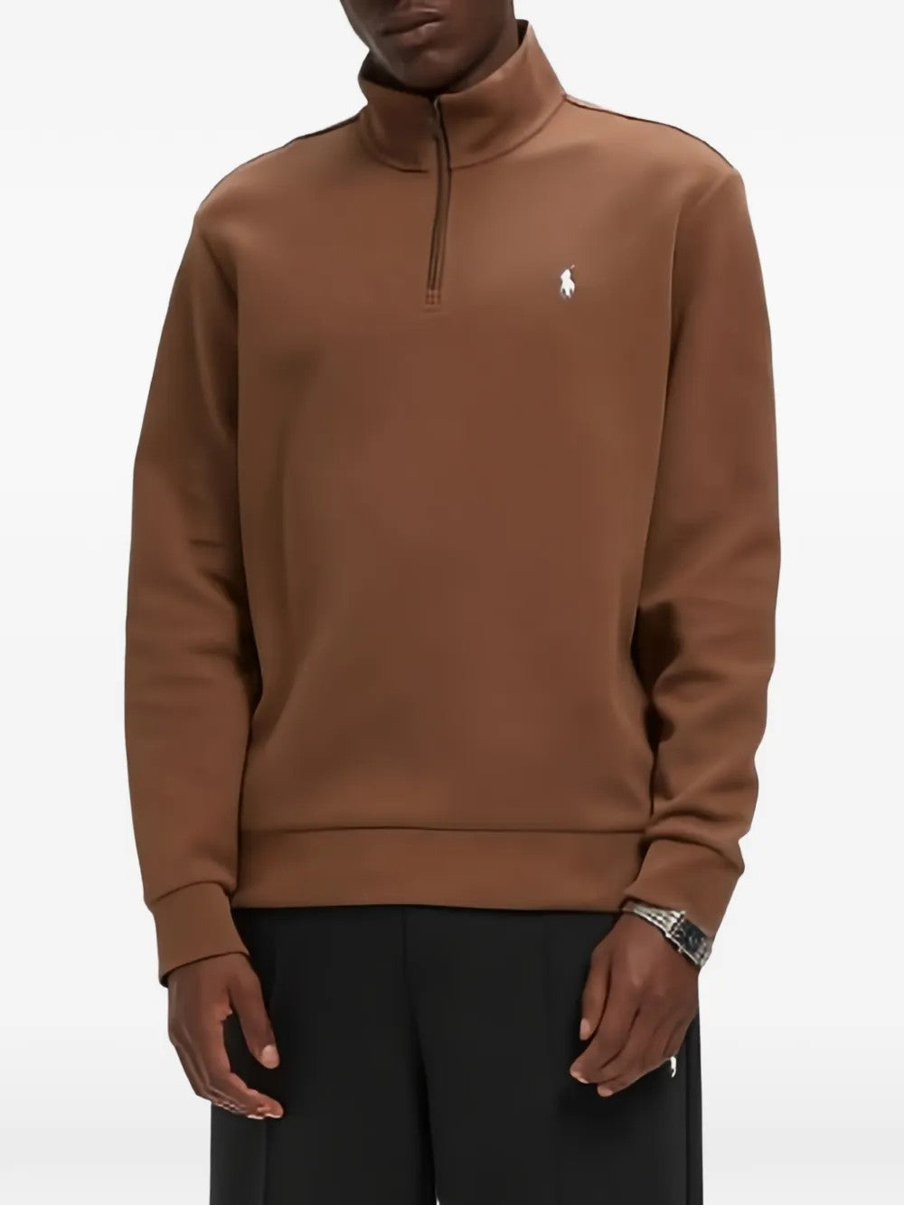 Brown knitwear worn by a person, showing the knitwear fit
