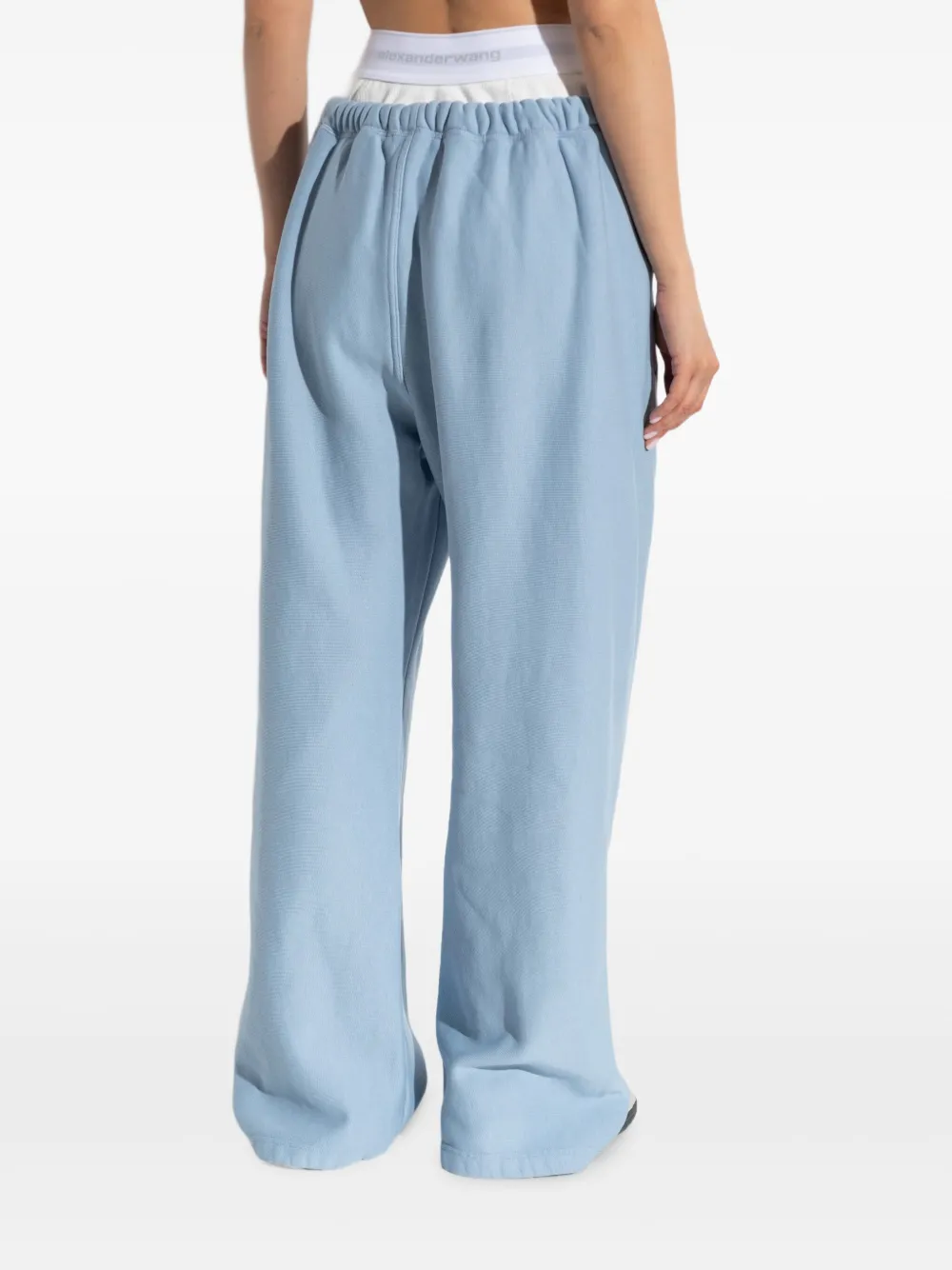Blue pants worn by a person, showing the pants' fit