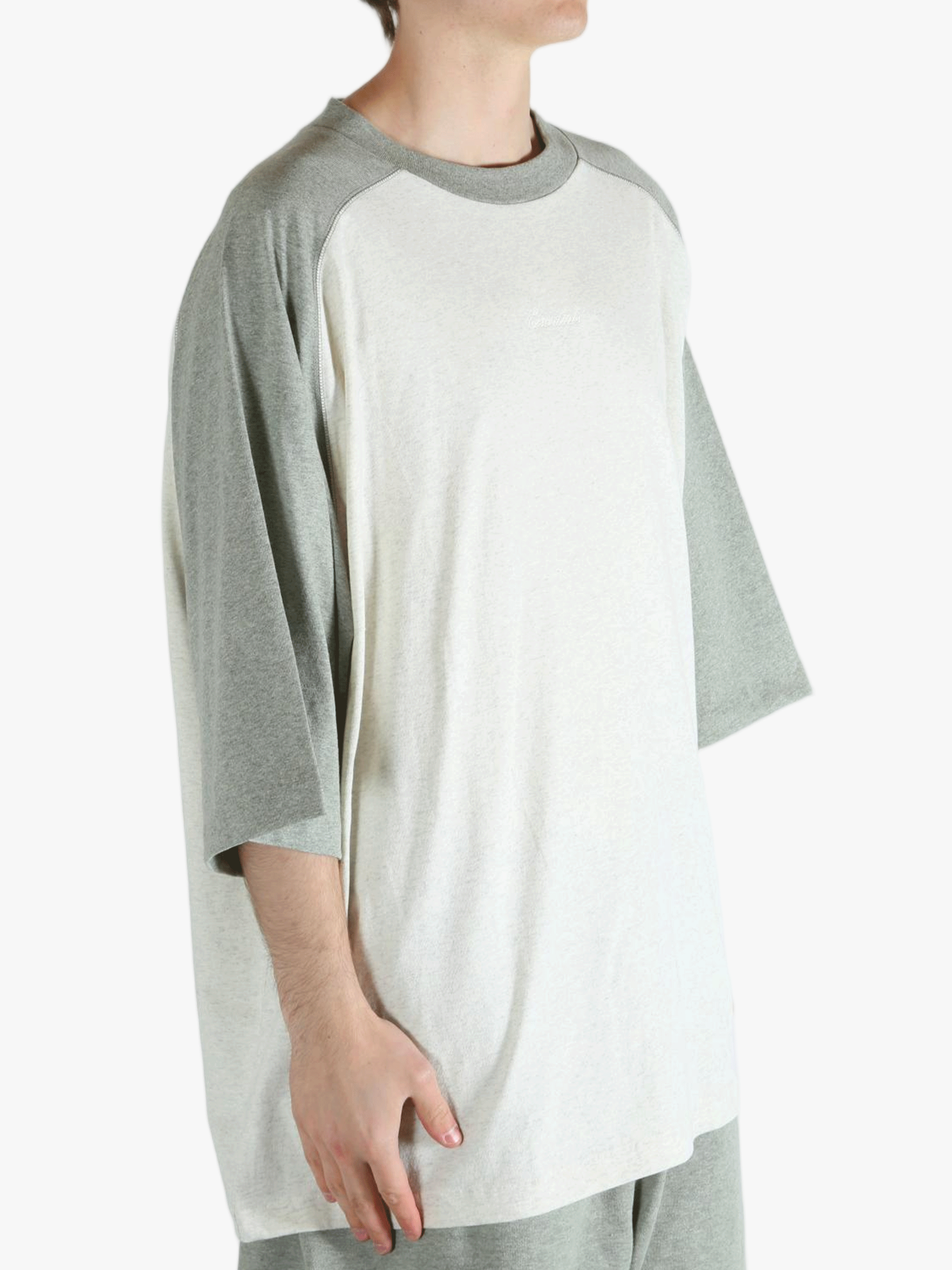 White t-shirt worn by a person, showing the shirt's fit