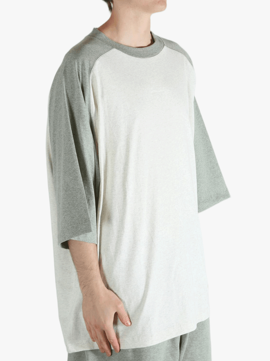 White t-shirt worn by a person, showing the shirt's fit