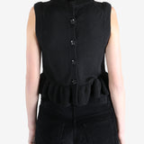 Black top worn by a person, showing the top's fit