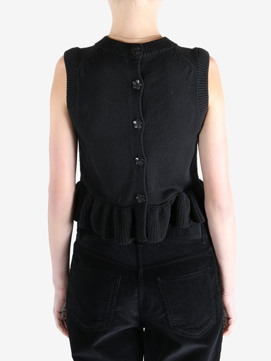 Black top worn by a person, showing the top's fit