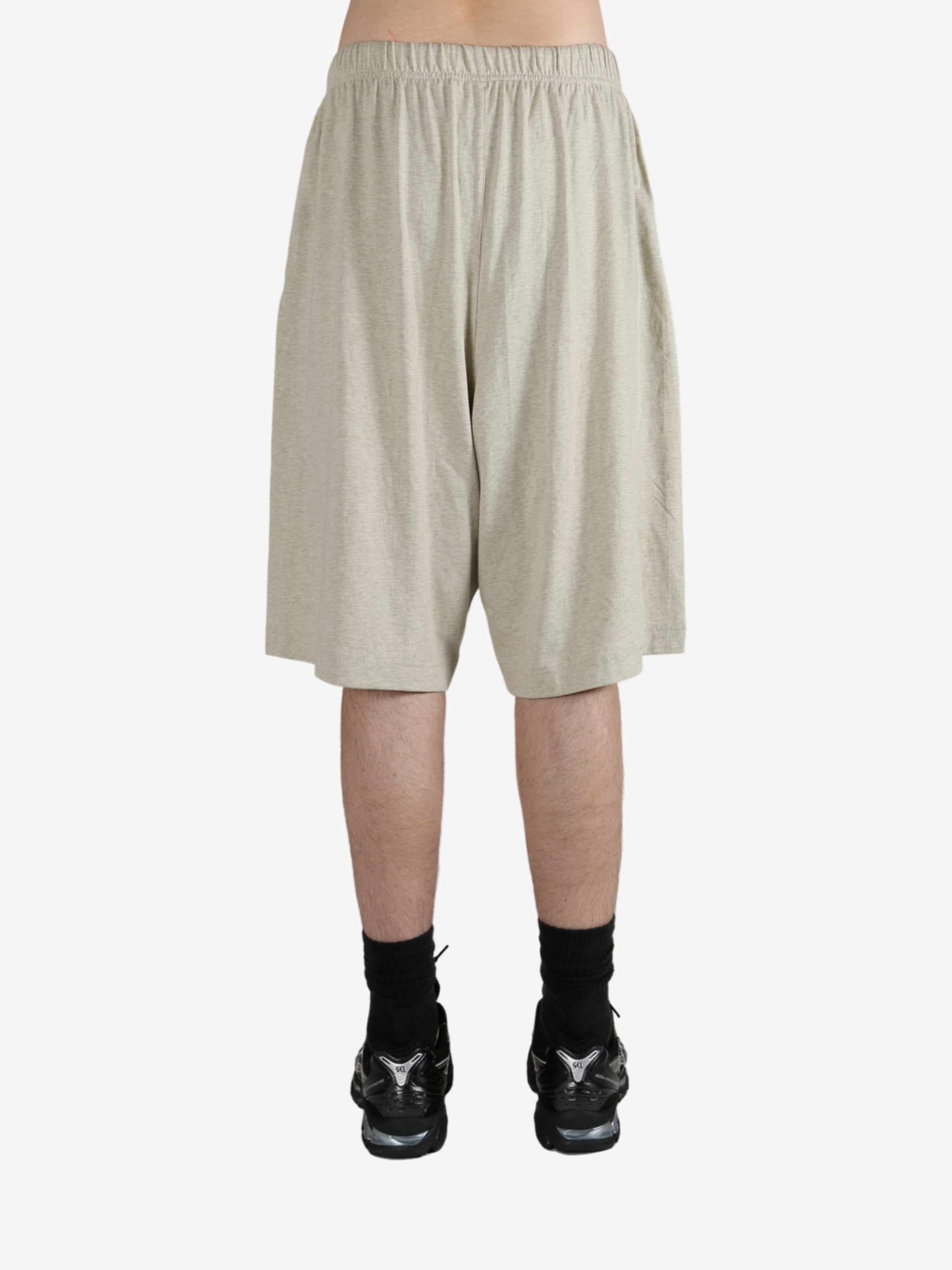 Grey shorts worn by a person, showing the shorts fit