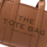 Close up of brown bags, showing texture of the leather fabric