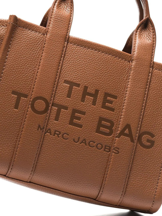 Close up of brown bags, showing texture of the leather fabric