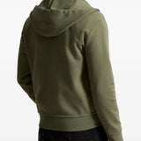 Green hoodie worn by a person, showing the hoodie fit