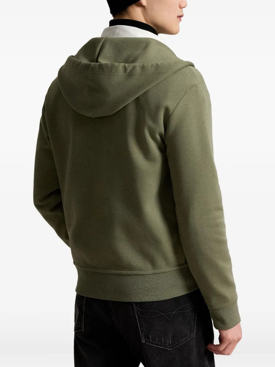Green hoodie worn by a person, showing the hoodie fit