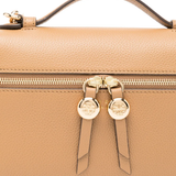 Close up of Tan bags, showing texture of the cow leather fabric