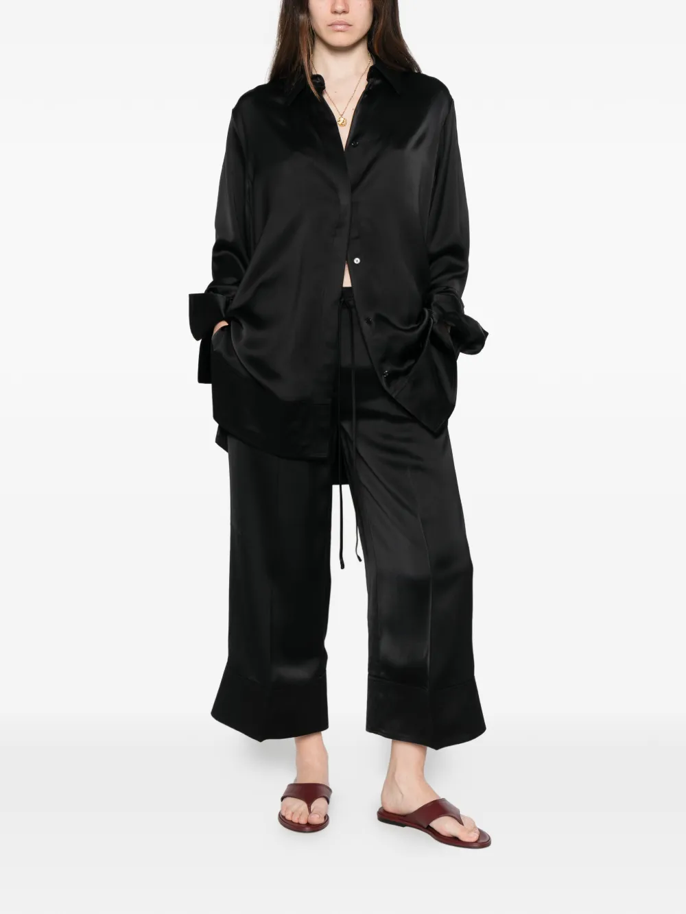 Black pants worn by a person, showing the pants' fit