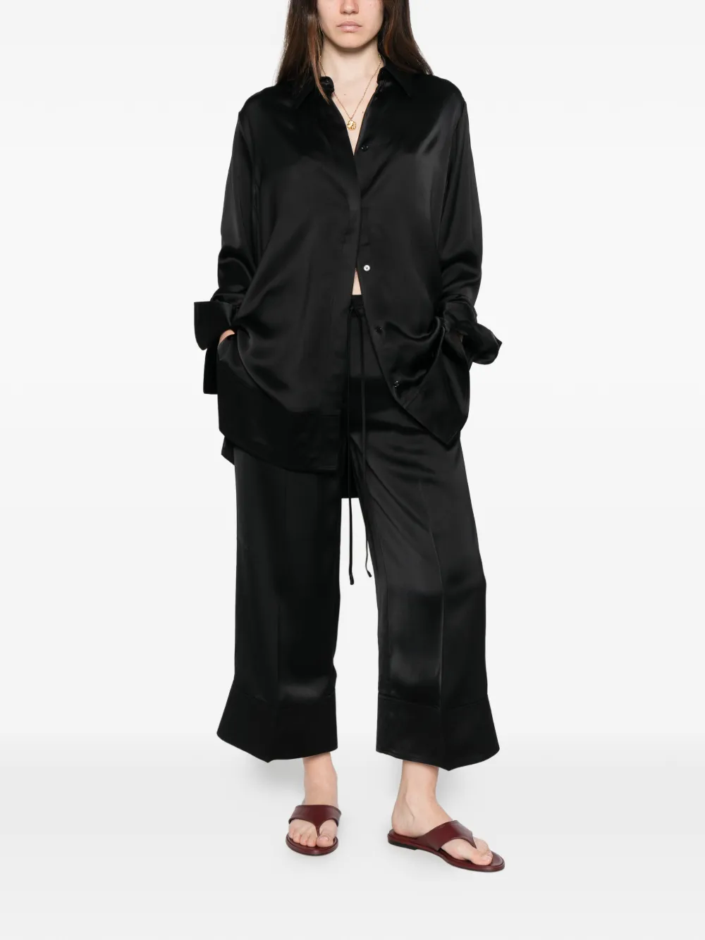 Black pants worn by a person, showing the pants' fit