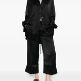 Black pants worn by a person, showing the pants' fit