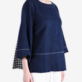 Navy top worn by a person, showing the top fit