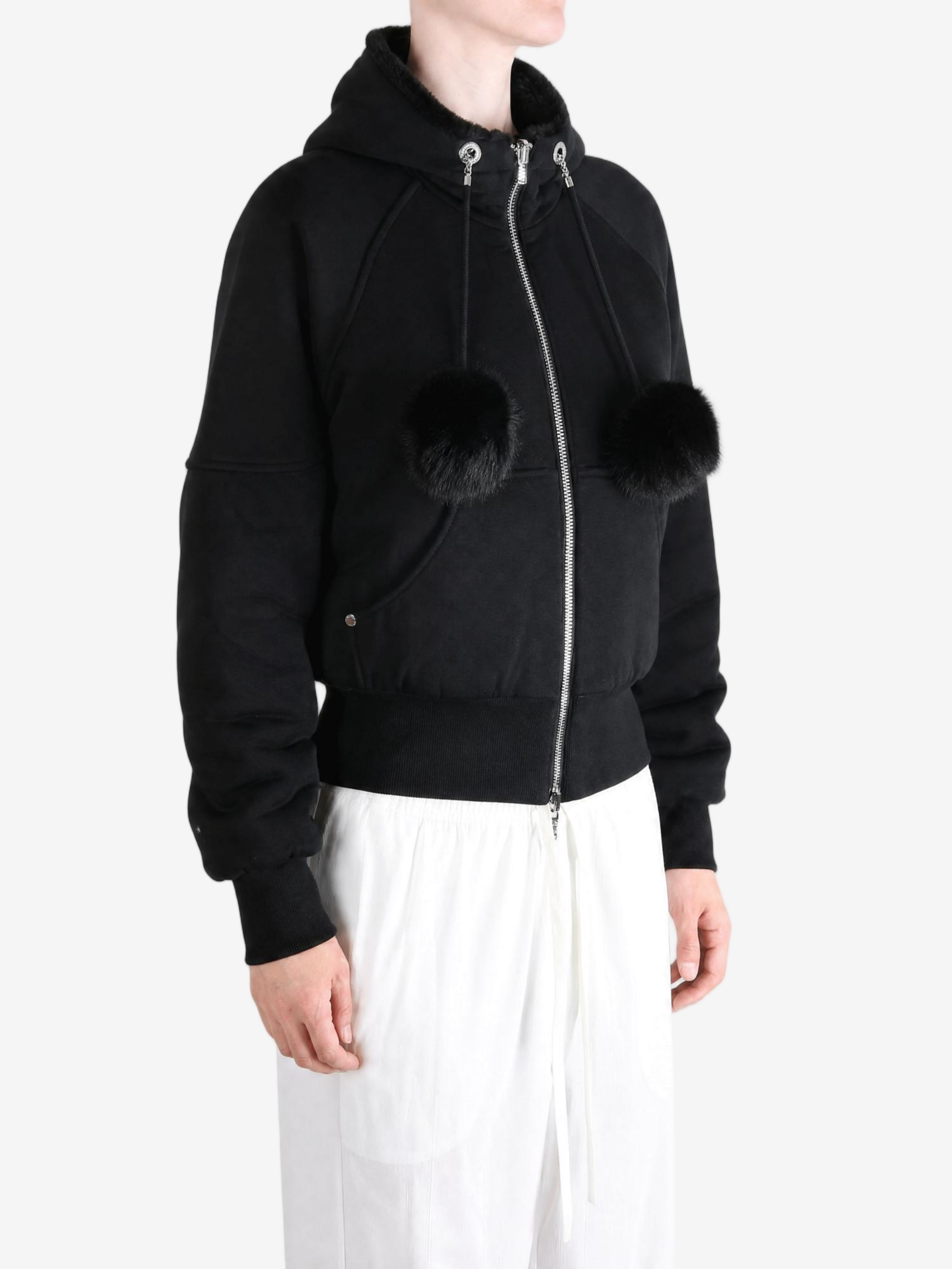 Black knitwear worn by a person, showing the knitwear fit