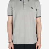 Grey shirt worn by a person, showing the shirt's fit 