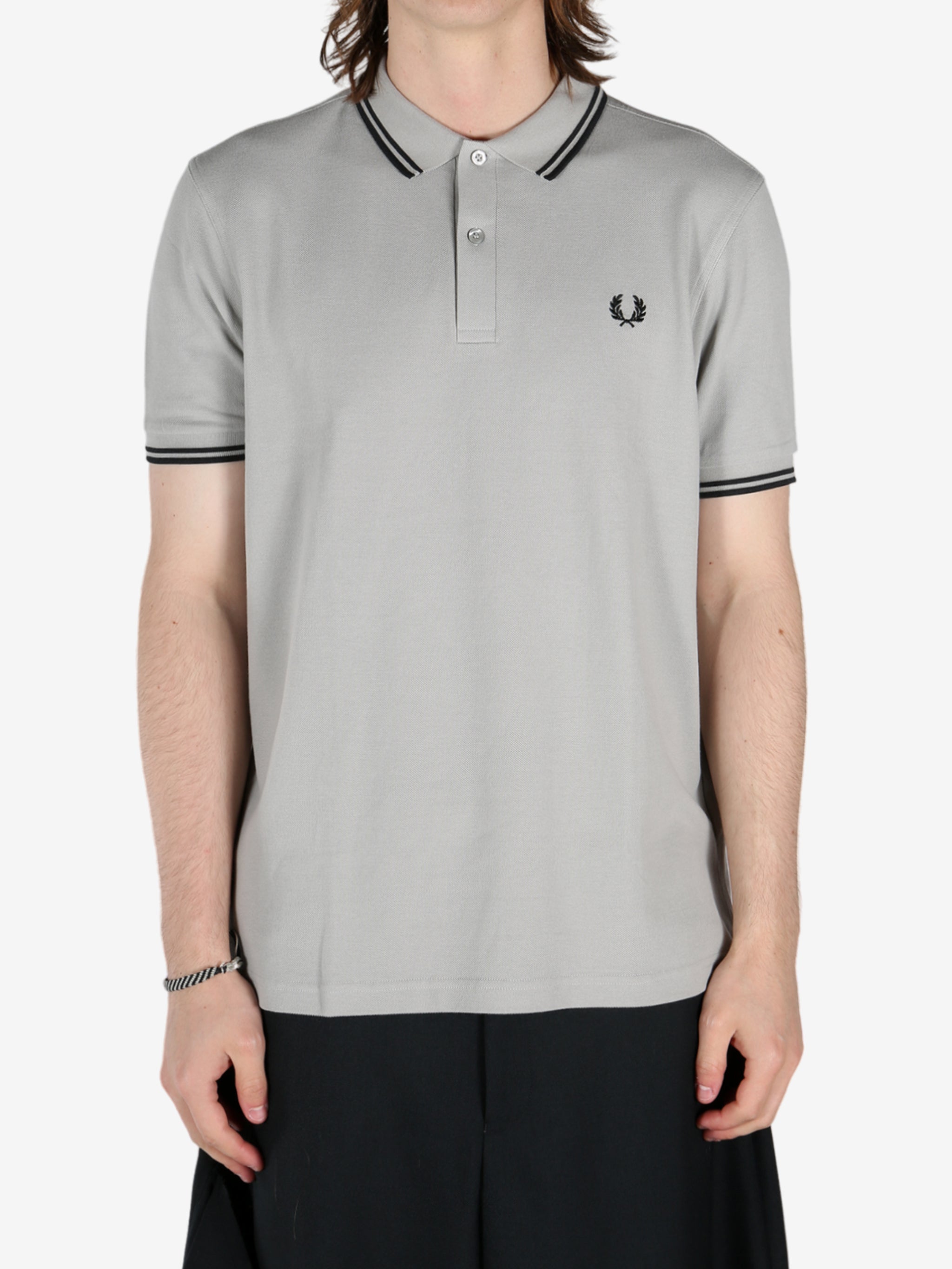 Grey shirt worn by a person, showing the shirt's fit 