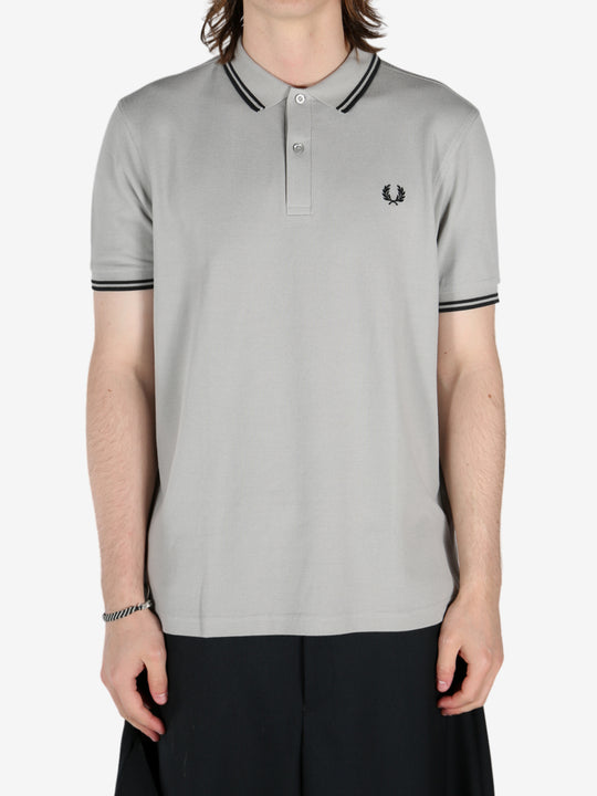 Grey shirt worn by a person, showing the shirt's fit 