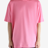 Pink t-shirt worn by a person, showing the shirt's fit