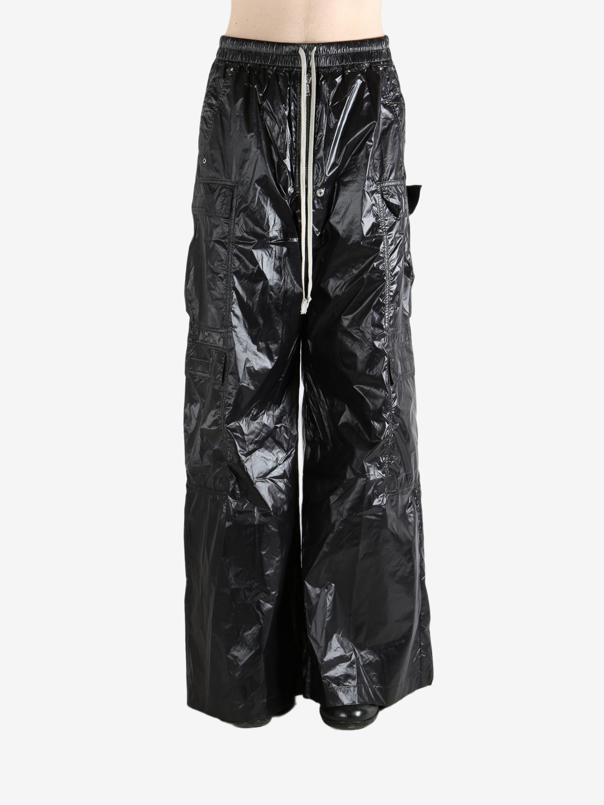 Black pants worn by a person, showing the pants' fit