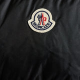 Close up of Black jacket, showing texture of the 100% recycled polyamide made fabric