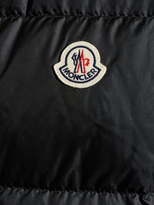 Close up of Black jacket, showing texture of the 100% recycled polyamide made fabric