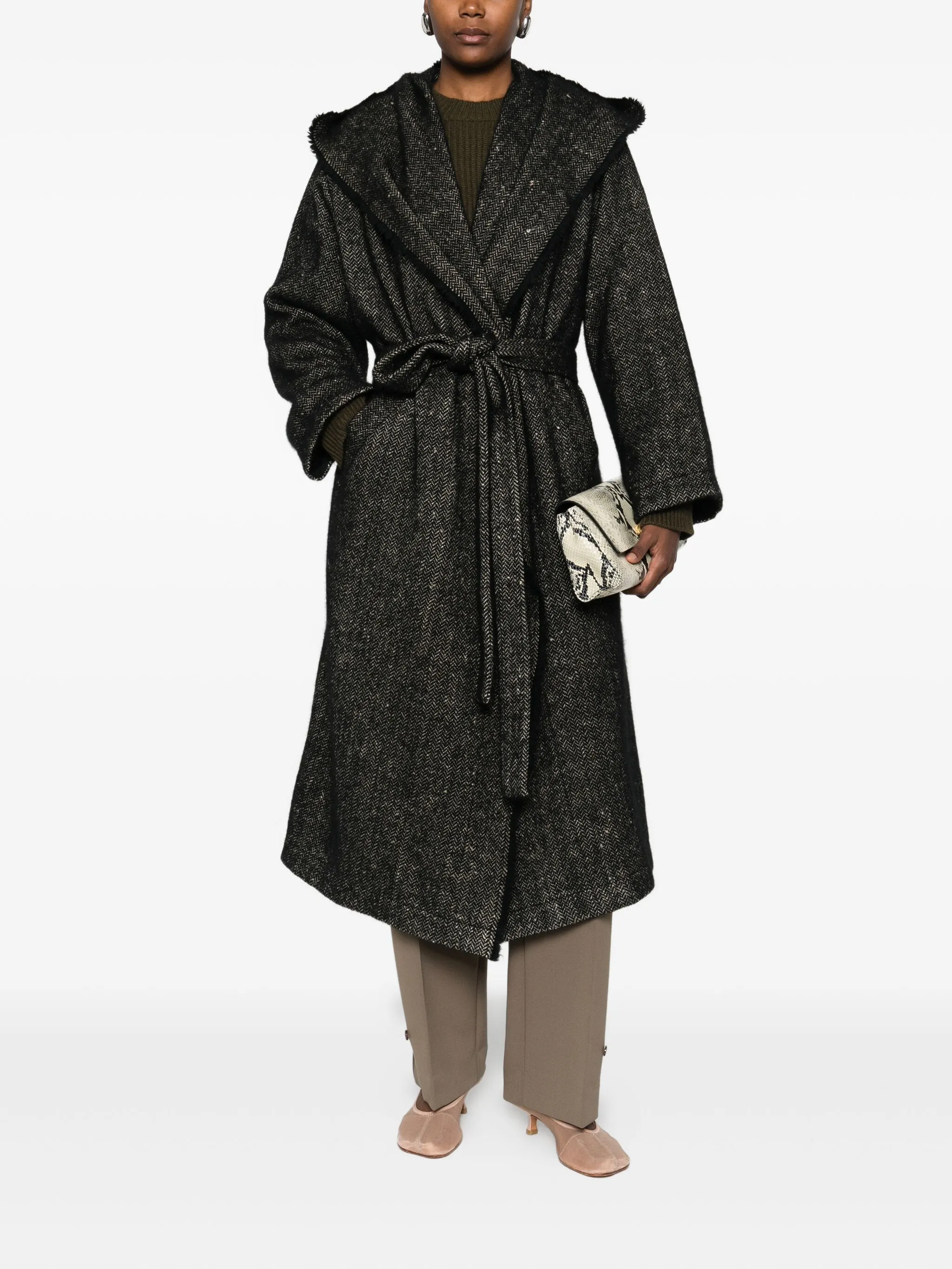 Black coat  worn by a person, showing the coat's fit