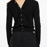 Black knitwear worn by a person, showing the knitwear fit
