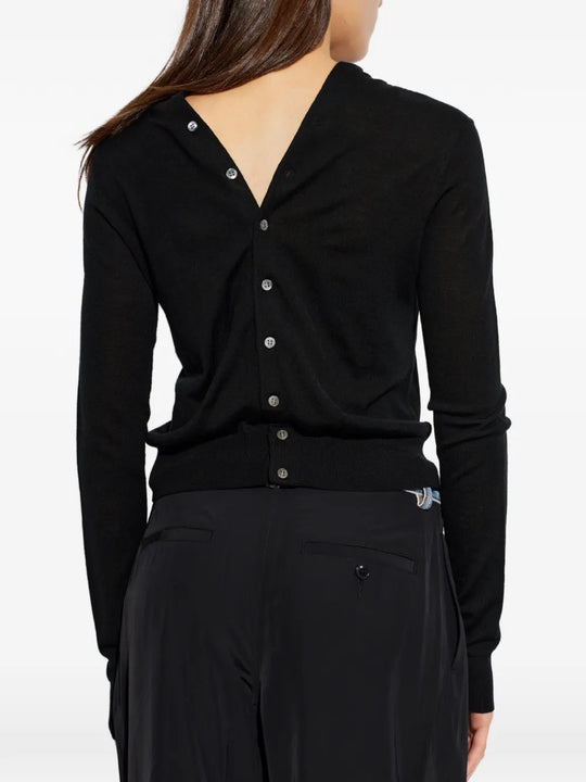 Black knitwear worn by a person, showing the knitwear fit
