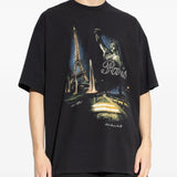 Black t-shirts worn by a person, showing the t-shirts fit