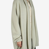 Green cardigan worn by a person, showing the cardigan fit