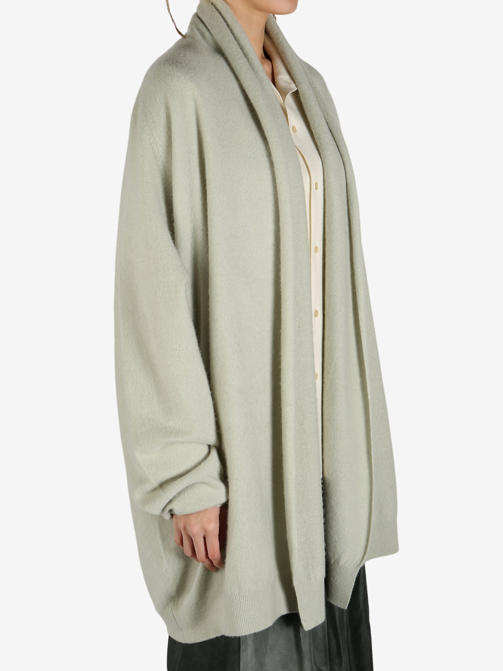 Green cardigan worn by a person, showing the cardigan fit