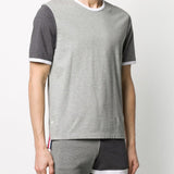 Grey T-shirt worn by a person, showing the shirt’s fit