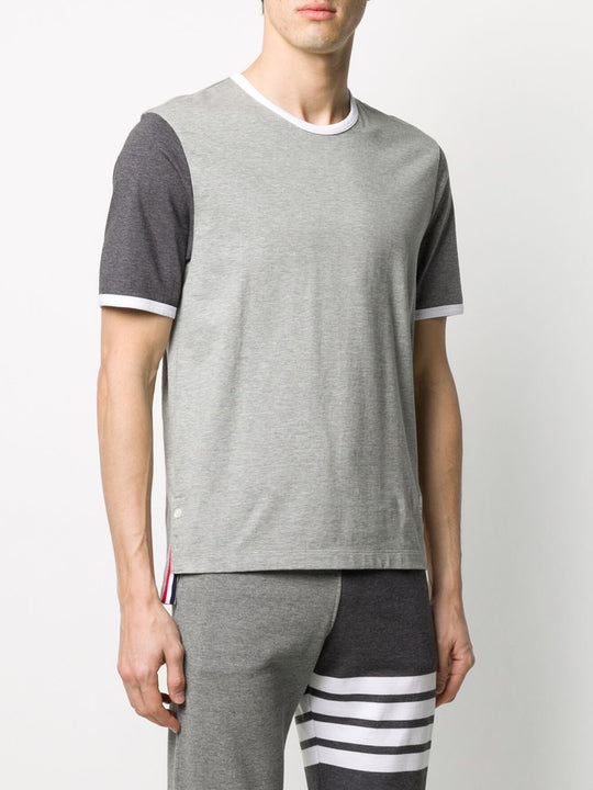 Grey T-shirt worn by a person, showing the shirt’s fit