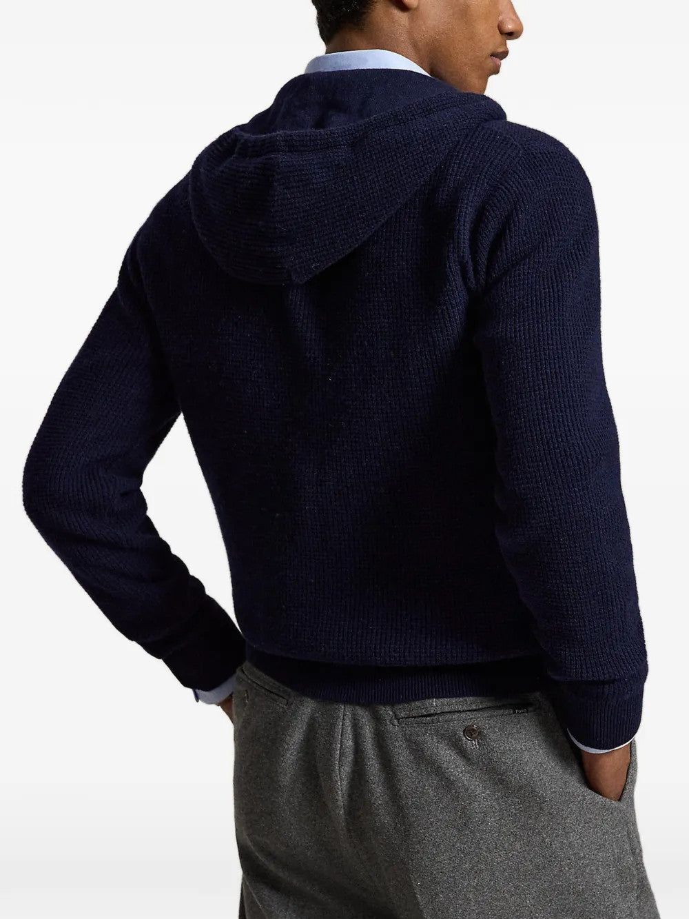 Navy knitwear worn by a person, showing the knitwear fit