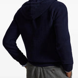 Navy knitwear worn by a person, showing the knitwear fit