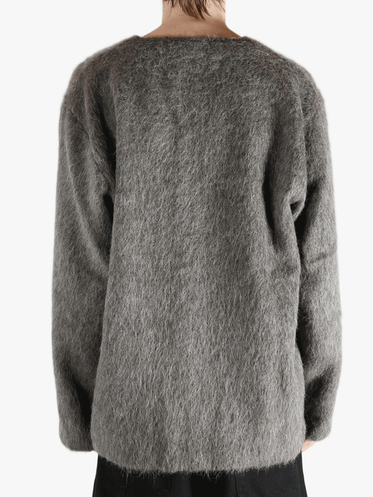 Grey cardigan worn by a person, showing the cardigan's fit