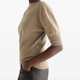 Tan knitwear worn by a person, showing the knitwear fit