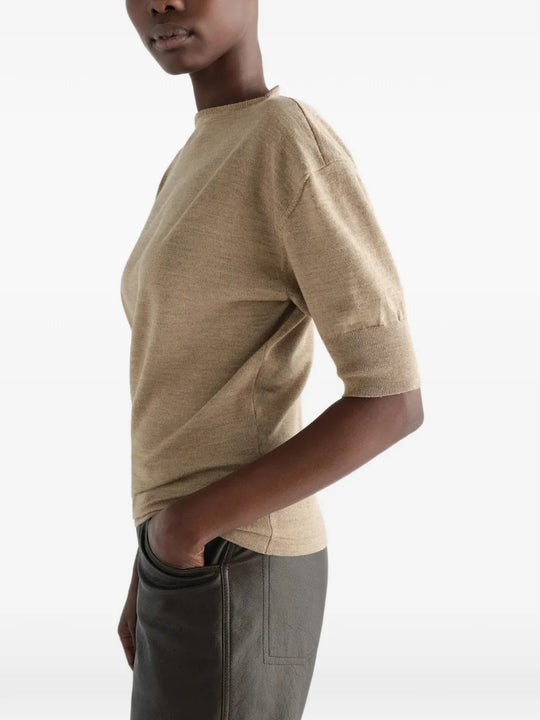 Tan knitwear worn by a person, showing the knitwear fit