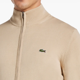 Close up of tan sweater, showing texture of the cotton fabric