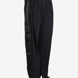 Black pants worn by a person, showing the pants fit