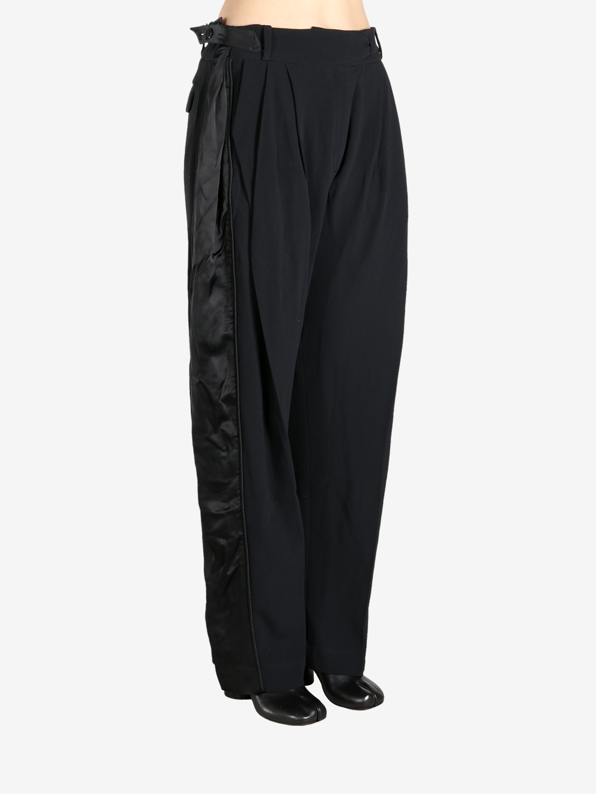 Black pants worn by a person, showing the pants fit