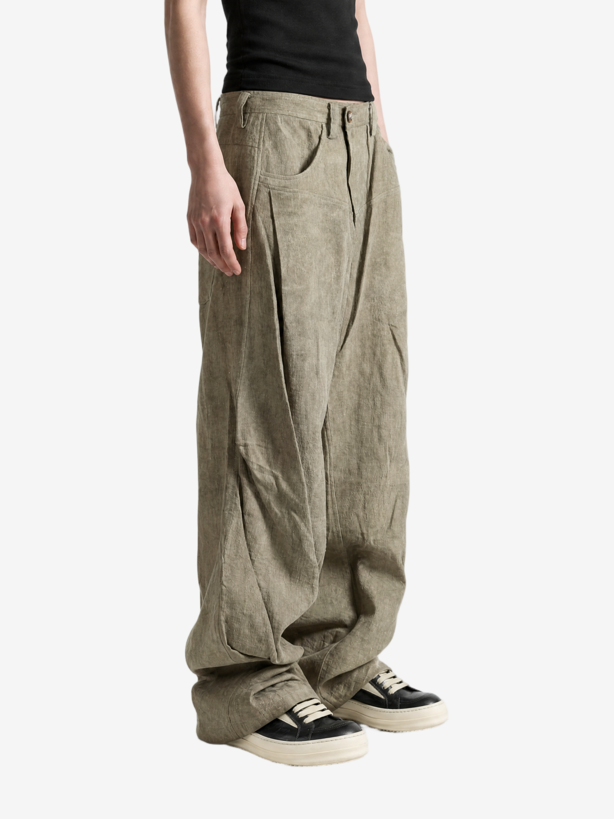 Green jeans worn by a person, showing the jeans fit
