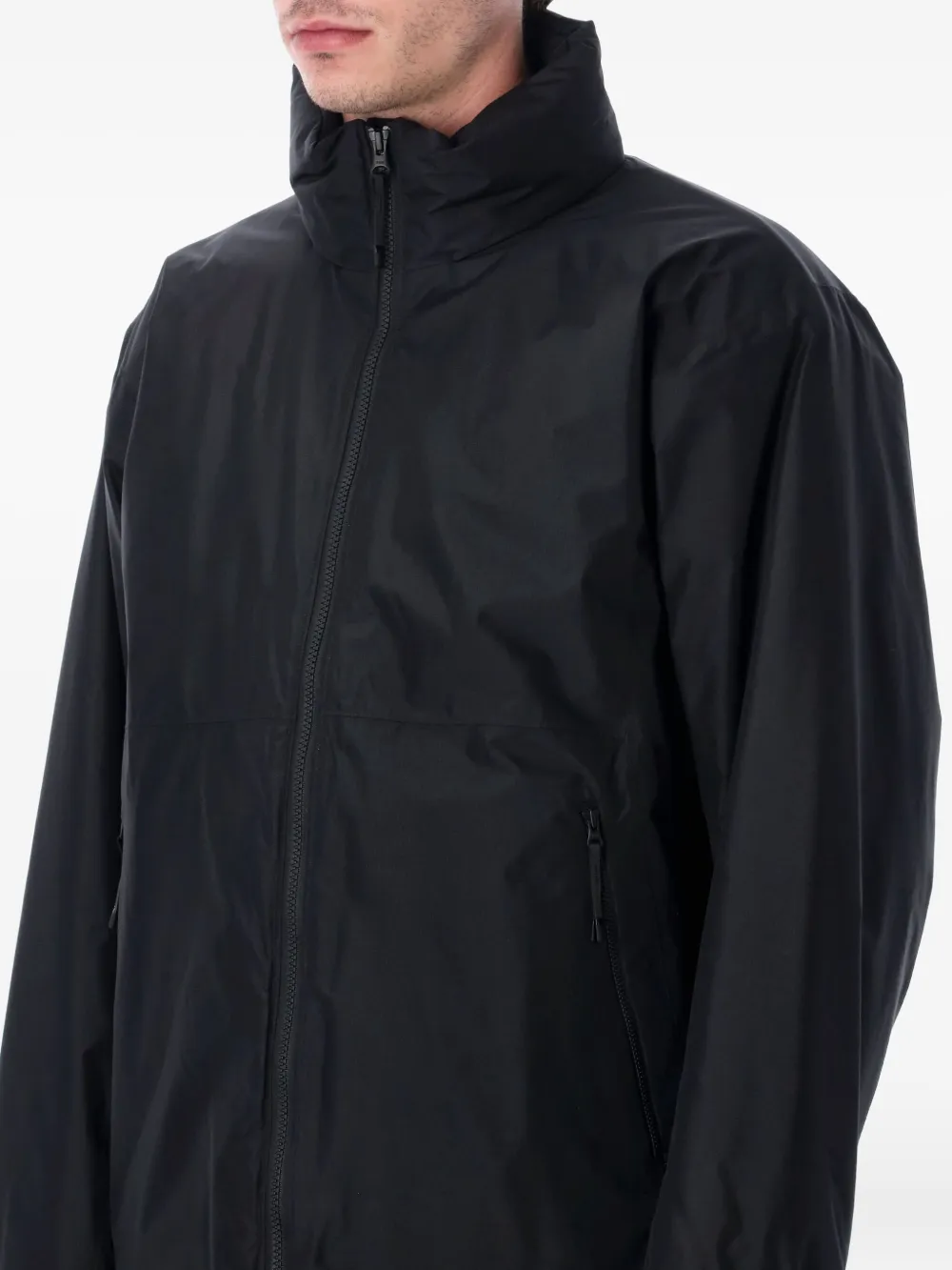 Black jackets worn by a person, showing the jackets fit