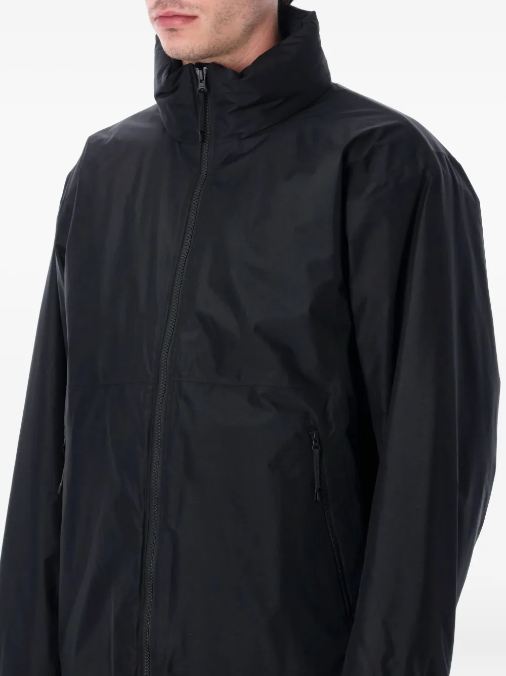 Black jackets worn by a person, showing the jackets fit