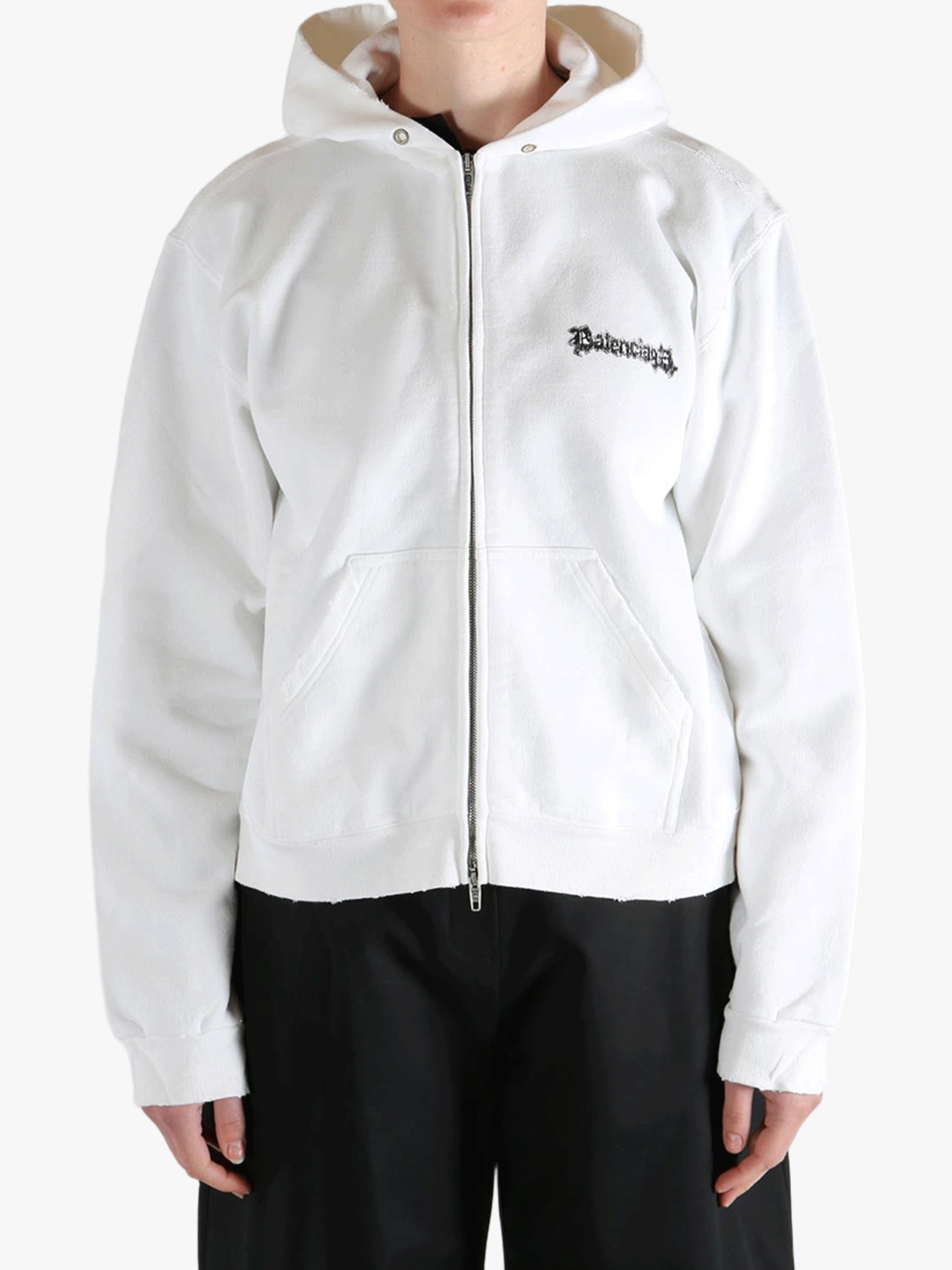 White hoodie worn by a person, showing the shirt's fit